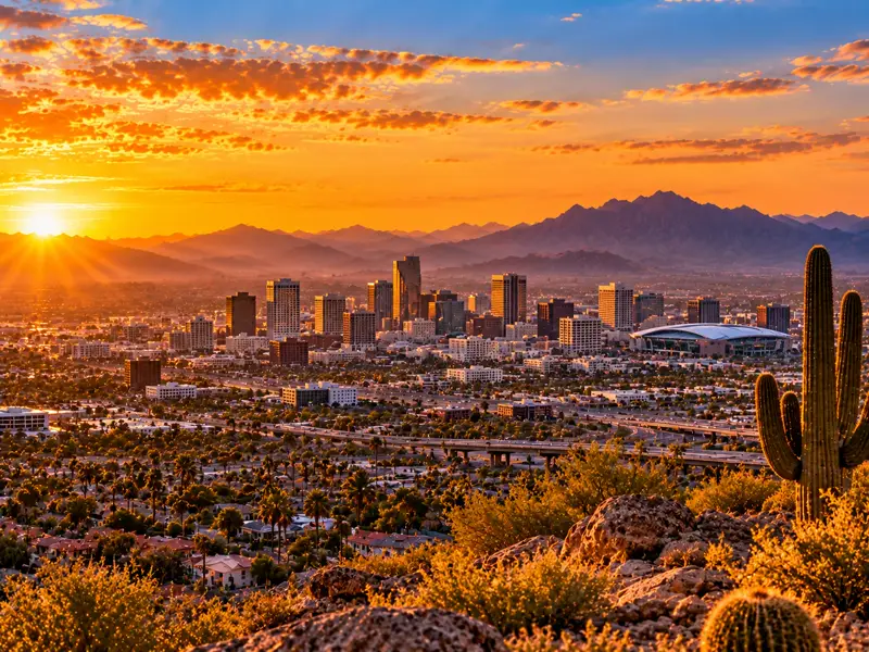 AI-generated interpretation of Phoenix skyline and desert mountains at sunset